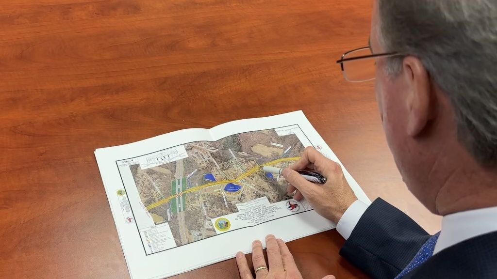 Kevin Mahoney looking at a map of the Archdale Road widening project from N.C. D..O.T.